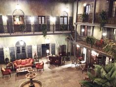 an indoor courtyard at night with tables and chairs