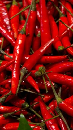 many red peppers are piled up together