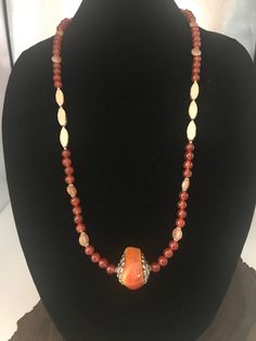 Beautiful amber colored carnelian statement necklace. These beads are so pretty and are about 8mm. I accented them with some czech horse hound cream color stones. It made it so beautiful. I added a resin style rock pendant that sets it off. I used resin so it wouldn't be to heavy. This necklace ends with sterling silver toggle clasp. This is one stylish pendant necklace. I also added earrings that match perfectly. Earrings are very light weight. They are made of resin and hang 2 inches. I also have another pair of kidney shape wire with carnelian and czech beads if interested. They hang about 3 inches long. Such beautiful colors together. I love it.  Free gift with every purchase. Anit-Tarnish Locking bag to store your beautiful jewelry. Elegant Orange Hand-strung Necklace, Spiritual Brown Necklace With Faceted Beads, Elegant Polished Carnelian Beads, Elegant Orange Agate Necklace, Carnelian Necklaces With Large Beads, Hand-strung Amber Jewelry With Round Beads, Unique Carnelian Necklaces With Large Beads, Hand-strung Round Amber Bead Jewelry, Gold Beaded Necklaces With Natural Stones And Czech Glass