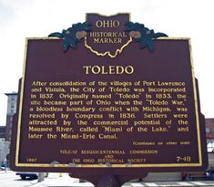 the historical marker toledo is located in front of an old building