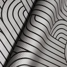 an abstract pattern with black and white lines on the fabric, as well as text that reads