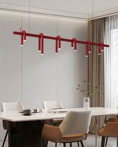 a dining room table with chairs and lights hanging from it's red rods over it