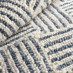 closeup of blue and white rugs on the floor in an area that looks like it has been made out of wool