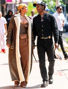 a man and woman walking down the street