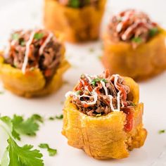 small appetizers on a white plate with garnishes and parsley