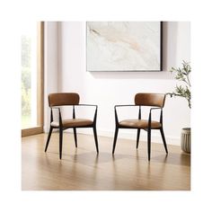 two chairs sitting next to each other on top of a hard wood floor in front of a painting