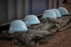 blue helmets are lined up on the ground