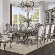 a dining room table with chairs and a chandelier