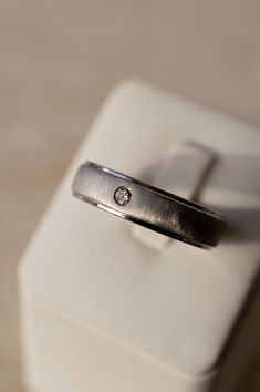 This band is set in flat profile band, brushed finish on centre surface, and a round diamond (provided by client) flush set in the centre. The band is 6mm wide Wedding Ring Pair, Mens Wedding Bands, Custom Wedding, Round Diamond, Precious Metals, Lab Grown, Wedding Band, Wedding Ring