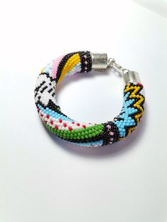 Feel the Boom 💣 with this colorful crocheted bracelet.  This item is so versatile it can make each and every outfit pop. Trendy Multicolor Braided Bracelets With Round Beads, Casual Multicolor Braided Bracelets With Colorful Beads, Trendy Multicolor Braided Bracelets, Multicolor Crochet Bohemian Jewelry, Casual Multicolor Braided Bracelets With Round Beads, Multicolor Braided Bead Bangle Bracelet, Multicolor Braided Bangle Bracelets For Friendship, Multicolor Braided Bracelet Bangle, Multicolor Braided Bangle Bracelet