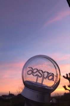 a close up of a street light with the sky in the background