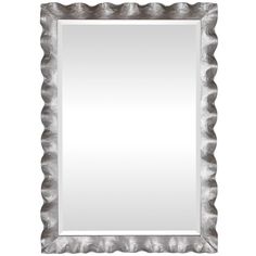 a silver framed mirror on a white wall