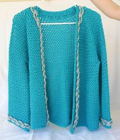 "Crochet women's jacket. Turquoise, grey. This beautiful women's jacket is perfect when you need some extra warmth. The long sleeved jacket is crocheted with a wonderfully soft and bright turquoise yarn and is trimmed in light grey. The yarn has a sheen to it which adds to it's beauty and makes the grey look almost silver. The fabric is quite stretchy which is great for wearing over anything. Machine washable Women's medium. 22\" from neck to lower edge. 36\" at bust. 45\" at lower edge. 23\" fr Light Blue Long Sleeve Outerwear For Layering, Light Blue Outerwear For Winter Layering, Fitted Light Blue Cardigan For Winter, Turquoise Long Sleeve Winter Outerwear, Fitted Light Blue Winter Cardigan, Turquoise Long Sleeve Outerwear For Winter, Turquoise Long Sleeve Sweater For Winter, Casual Turquoise Winter Outerwear, Turquoise Long Sleeve Outerwear For Spring