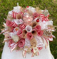 a christmas wreath made out of burlocks and candy canes on top of a white towel