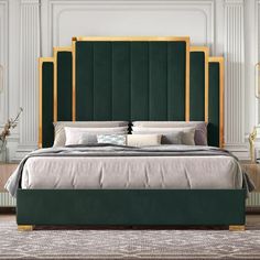 a bed with green velvet headboard and gold trimmings in a white bedroom