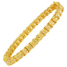 This beautiful tennis bracelet features 42 perfectly matched Fancy Yellow Cushion Cut Diamonds set in a single line bracelet. Measure 6.75 inches. Set in 18 Karat Yellow Gold. Yellow Diamond Bracelet, Canary Diamond, Yellow Cushion, Platinum Bracelet, Fancy Yellow Diamond, Yellow Jewelry, Colorless Diamond, White Gold Bracelet, Cushion Cut Diamonds