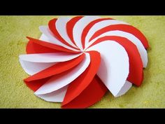 a red and white paper decoration on the floor