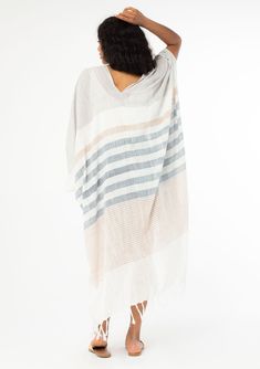 A versatile cotton bohemian beach kimono in a neutral stripe. FINAL SALE Mixed stripe print Cotton Relaxed, flowy fit Kimono sleeves Mid-length Fringe hemline Billowy silhouette Long & lightweight Open front Bohemian beach kimono From the beach to the streets, this lightweight cotton kimono adds an effortless feel to any outfit. Featuring a fringe hemline, an easy open front, and a relaxed, billowy fit. Model is 5'9, garment is O/S.Style: I-10933 Striped Kaftan For Summer Beach Cover-up, White Cotton Cover-up For Warm Weather, Striped Kaftan For Spring Vacation, Spring Striped Kaftan For Beach Cover-up, Bohemian Linen Cover-up For Spring, Bohemian Striped Kaftan For Beach Cover-up, Spring Bohemian Linen Cover-up, Bohemian Striped Kaftan For Summer, Spring Beige Cotton Kaftan