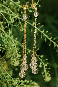 "These multiple strand layered crystal drop earrings are pure beauty! Secured to a 5mm plated earring post, 2 layered strands of delicate plated cable chain are linked to the studs with a 6mm clear Preciosa crystal bead. Cascading from the bead, the cable chains are staggered lengths and finished with a beautiful clear crystal beaded design of a 8mm round Preciosa crystal stacked with a 6mm and 5mm Preciosa crystal bicone bead. Each crystal beaded stack is finished with a glass seed bead matchin Wedding Crystal Earrings With Dangling Beads, Crystal Earrings With Dangling Beads For Wedding, Wedding Crystal Dangle Earrings With Faceted Beads, Faceted Crystal Drop Earrings For Wedding, Elegant Drop Crystal Earrings With Faceted Beads, Elegant Wedding Earrings With Faceted Beads, Wedding Crystal Earrings With Faceted Beads, Faceted Crystal Wedding Earrings, Wedding Drop Earrings With Faceted Beads