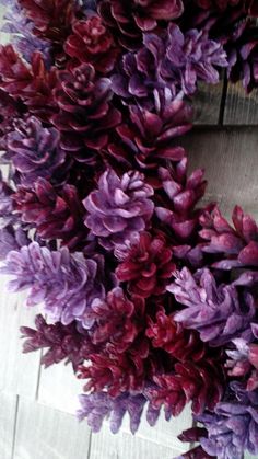 purple and red flowers are arranged in a wreath