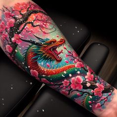 a colorful tattoo with a dragon on it's arm and cherry blossom trees in the background