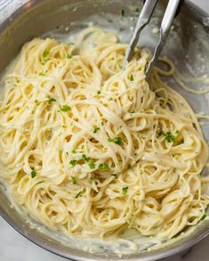 a bowl filled with pasta and topped with parsley