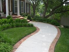 a brick walkway in front of a house