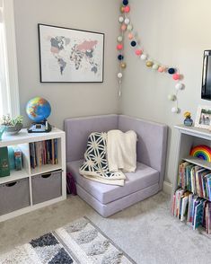 a room with a couch, bookshelf and various items on the shelves in it