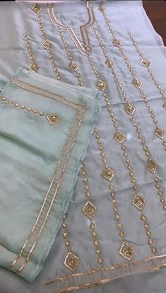 three different types of beaded cloths on a white tablecloth with gold trim