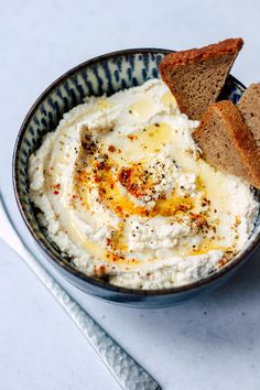 a bowl filled with mashed potatoes and bread