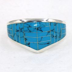 "Large beautiful blue faux turquoise sterling silver hinged cuff bracelet.  Marked 925.  Certain to be a treasure in your personal jewelry collection. FREE SHIPPING! Details:  Sterling Silver: (as shown in picture) Faux Turquoise: inlay Approximate Dimensions: 1 1/2 inch wide at top, inside circumference is 6 3/4 inches Wrist Size: 6 - 6 1/2 inches  Total Weight: 78.0 grams FREE domestic shipping by USPS Priority Mail delivery confirmation and includes insurance. If the item is to be shipped internationally Etsy will calculate postage. Please notify us at purchase if you are buying more than one item and we will gladly combine shipping. 7 day \"no hassle\" return policy money back guarantee. If for any reason you are not 100% thrilled with your purchase, please contact us and we will gladl Collectible Blue Turquoise Inlay Ring, Southwestern Style Nickel Free Blue Cuff Bracelet, Southwestern Blue Nickel-free Cuff Bracelet, Southwestern Style Blue Nickel-free Cuff Bracelet, Unique Blue Nickel-free Cuff Bracelet, Southwestern Blue Cuff Bracelet As Gift, Blue Inlay Bracelet Jewelry, Blue Inlay Bracelet, Blue Sterling Silver Cuff Bracelet With Gemstone