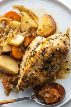 a white plate topped with chicken, potatoes and carrots