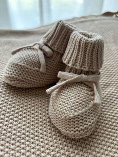 Cotton knit baby booties.  Available in 9cm approx (suitable for 0 to 6mths) and 11cm approx (suitable for 6 to 12mths). A great new baby gift, birth announcement or baby shower gift. Booties are soft and cosy for little feet! Pair with our blankets or comforters for the most perfect baby gift idea! Booties are made from 100% cotton. Cozy Cream Winter Booties, Cute Soft Sole Booties As Gift, White Knitted Booties For Winter, White Booties As Winter Gift, White Knitted Winter Booties, White Winter Booties As A Gift, White Winter Booties As Gift, Cute Knitted Booties As Gift, Cute Knitted Round Toe Booties