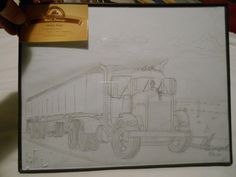 a drawing of a semi truck is shown in a frame with a card attached to it