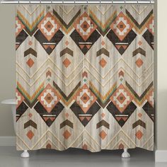 a shower curtain with an orange and brown pattern on the outside, in front of a white bath tub