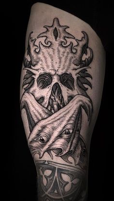 a man's leg with tattoos on it and an image of a skull in the middle