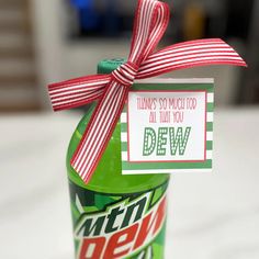 a green bottle with a red and white striped bow on it that says, think so much to all that you dew