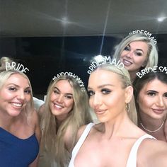 the bridesmaids are posing for a photo with their hair pinned in tiaras