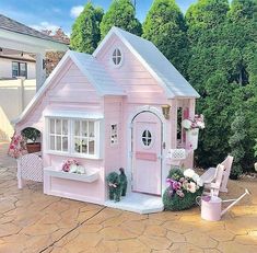 a pink doll house sitting on top of a patio