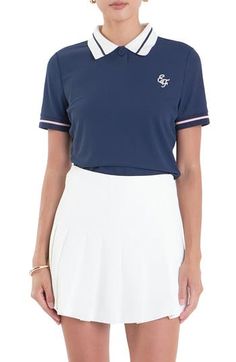 Chic tipping lends stylish interest to a preppy polo sporting a contrast collar and logo embroidery on the chest. Button half placket Point collar Short sleeves 100% polyester with 100% cotton contrast Hand wash, dry flat Imported Navy Polo Shirt With Contrast Collar, Navy Polo Shirt With Contrast Collar, Short Sleeve, Navy Classic Tops With Contrast Trim, Classic Navy Tops With Contrast Trim, Classic Navy Polo Shirt With Contrast Trim, Navy Top With Contrast Collar For Workwear, Navy Polo Shirt With Contrast Trim, Sporty Polo Collar Top With Contrast Trim, White Sporty Polo Shirt With Contrast Trim