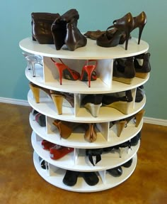 a stack of shoes sits on top of a shelf in the corner of a room