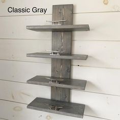 a shelf made out of wood with hooks on the bottom and two shelves below it