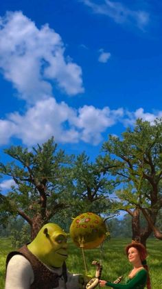 a woman sitting in the grass next to an animated character