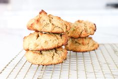 three cookies stacked on top of each other on a cooling rack in front of a window