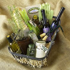 a basket filled with lots of different items on top of a bed covered in burlap