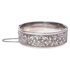 Deeply and intricately engraved on the front panel of this bangle is a classic swirl and textured design. Inner Diameter: 60mm Bangle Width: 19mm Weight: 37g Ornate Stamped Bracelets For Formal Occasions, Classic Etched Bangle Bracelet, Classic Etched Bangle Bracelets, Classic Engraved Sterling Silver Bangle Bracelet, Elegant Silver Bangle With Engraving Option, Formal Engraved Bangle Cuff Bracelet, Classic Etched Bangle Jewelry, Ornate Engraved Bangle For Formal Occasions, Classic Engraved Cuff Bangle Bracelet