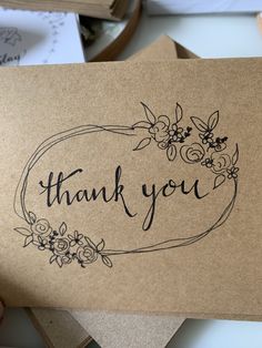 a thank you card with flowers on it and the words thank you written in black ink