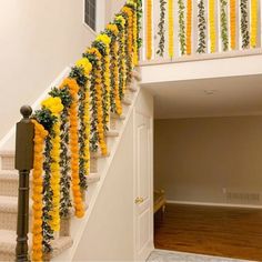 the stairs are decorated with flowers and garlands