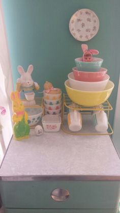 a stack of dishes sitting on top of a dresser