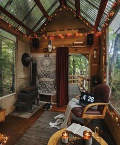 a living room filled with furniture and lots of lights on the ceiling, along with an open fire place